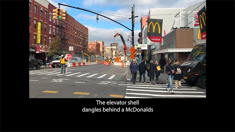 A crane lifts a metal shell that will house an elevator to provide long-belated access to a Greenpoint, Brooklyn, subway stop.